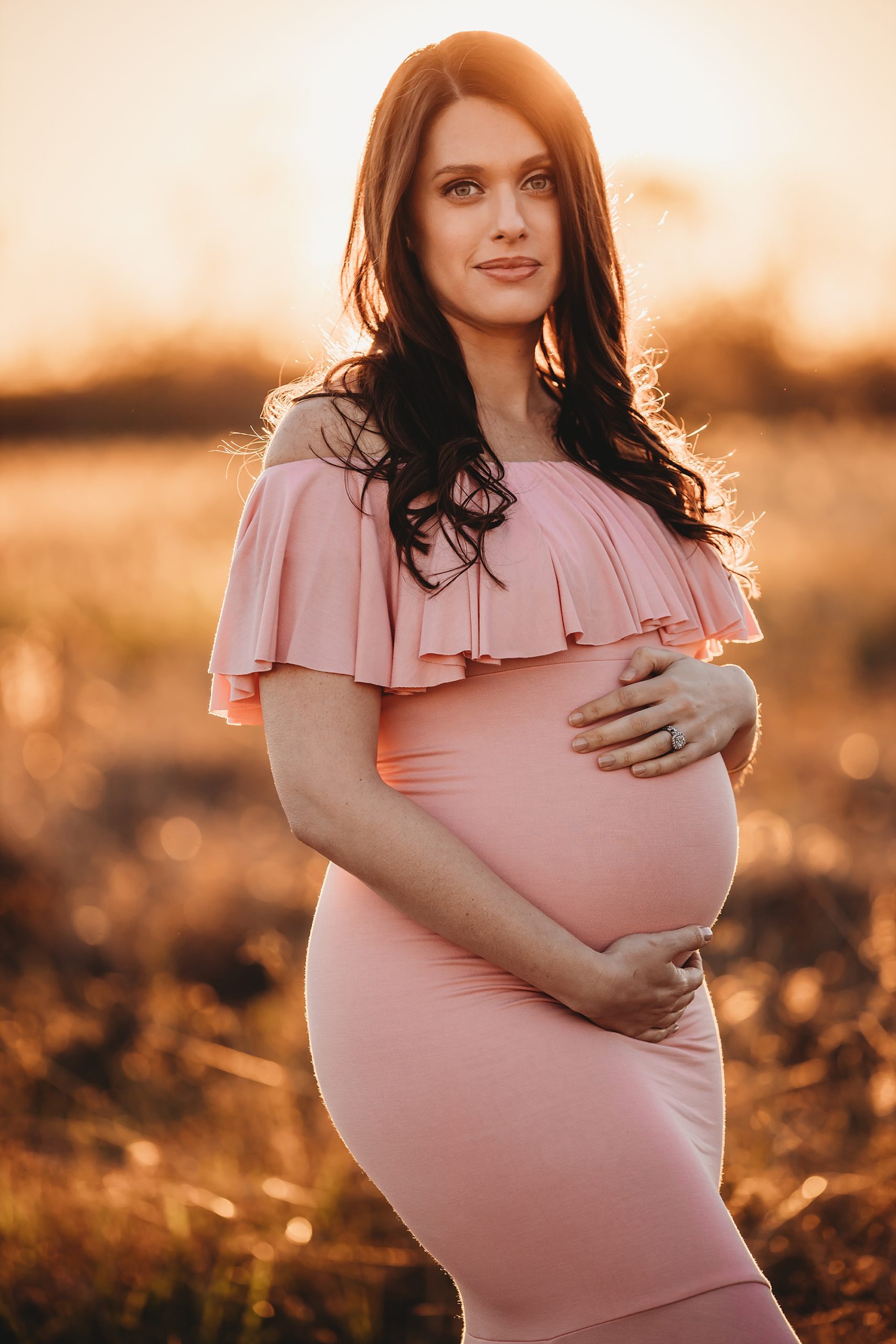 golden hour maternity photos in a field in Houston
