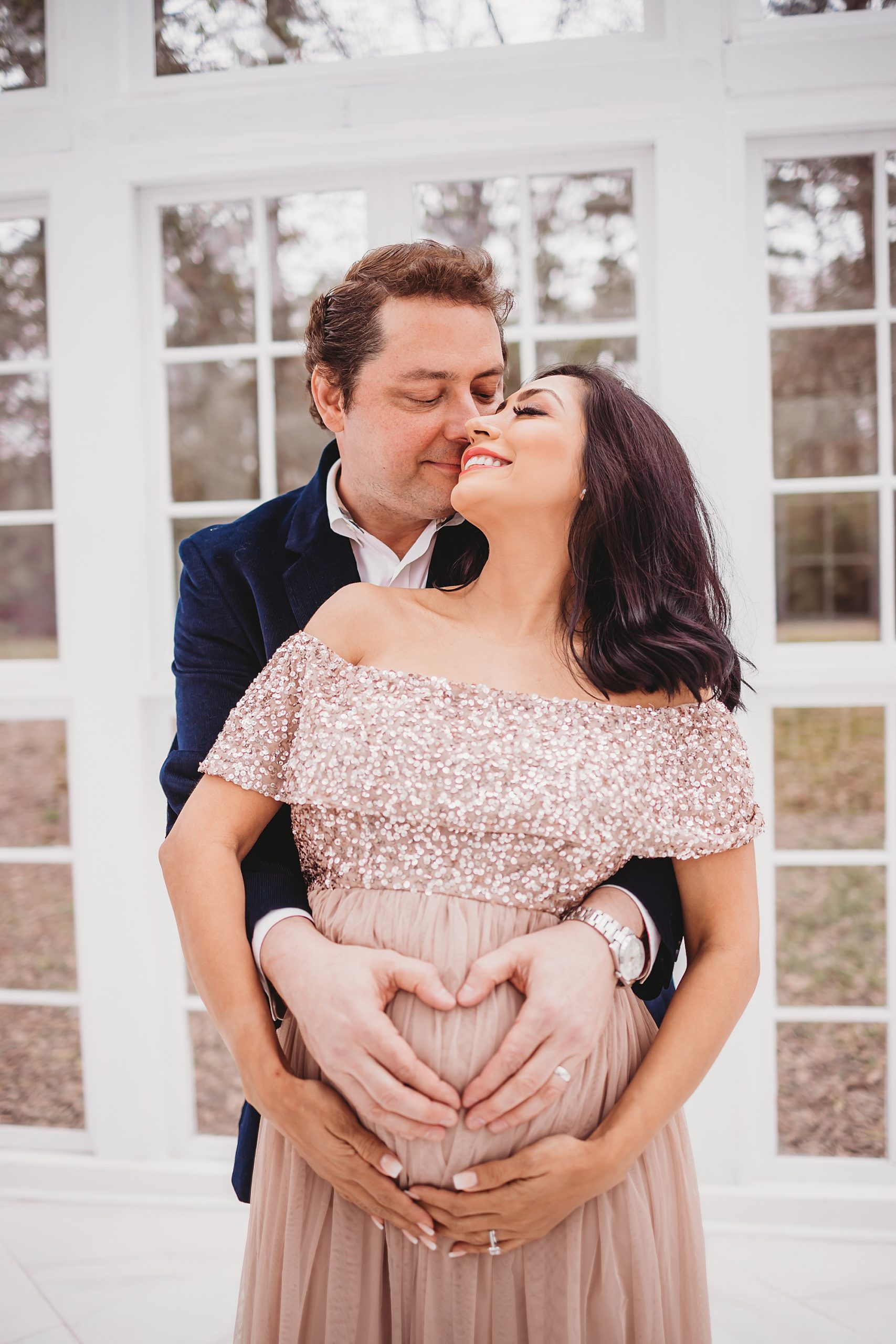 maternity photo with husband and wife hugging and looking at each other in Houston
