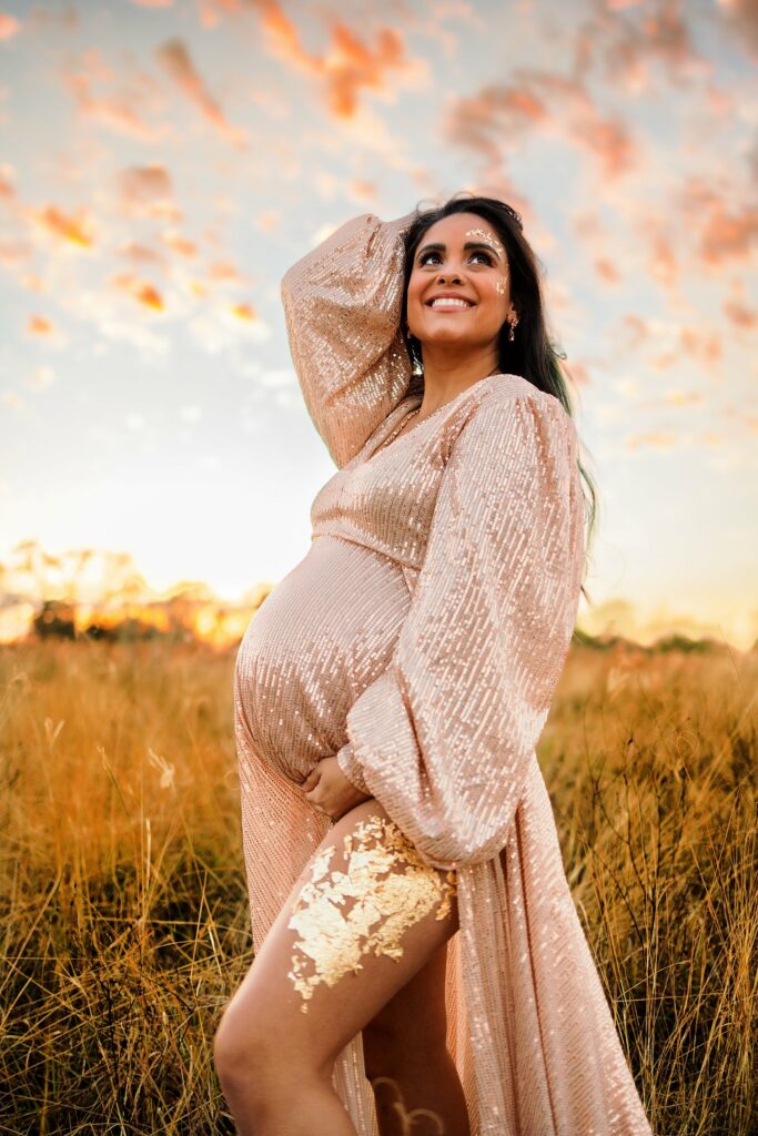 woman in a peach sparkly maternity gown